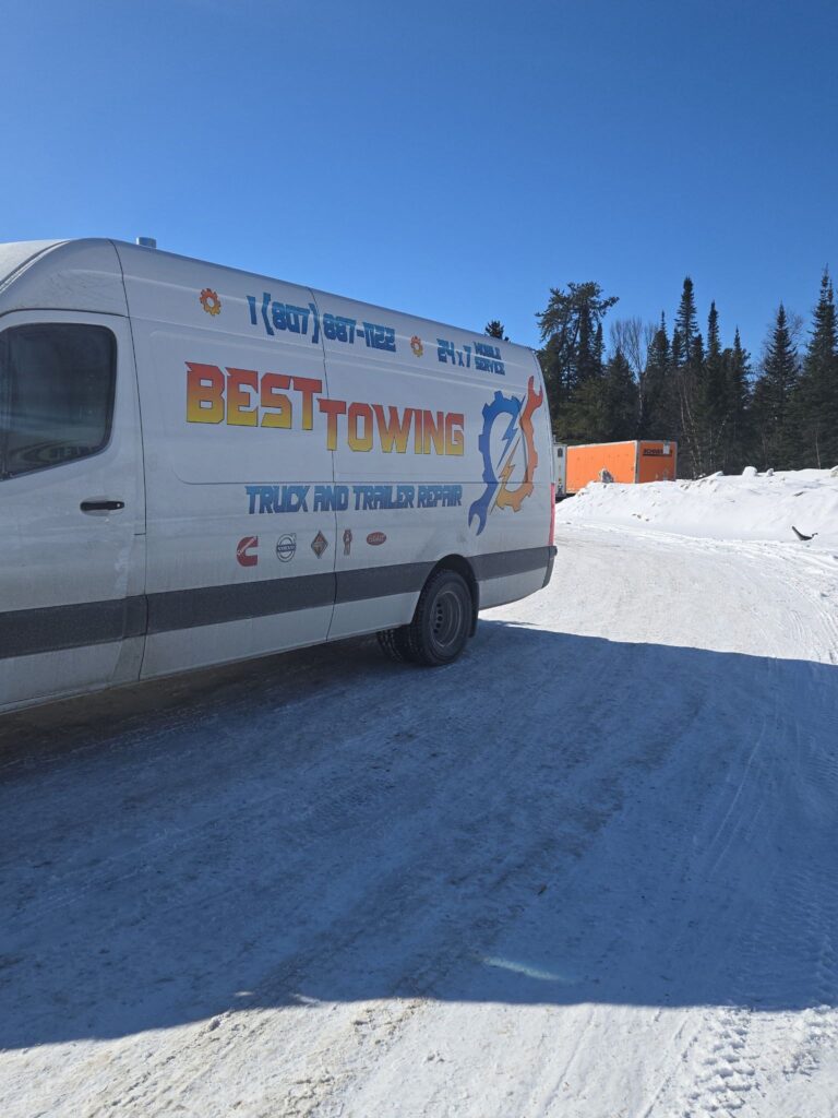 Best Towing service van for truck and trailer repair parked on a snowy road in Ontario.