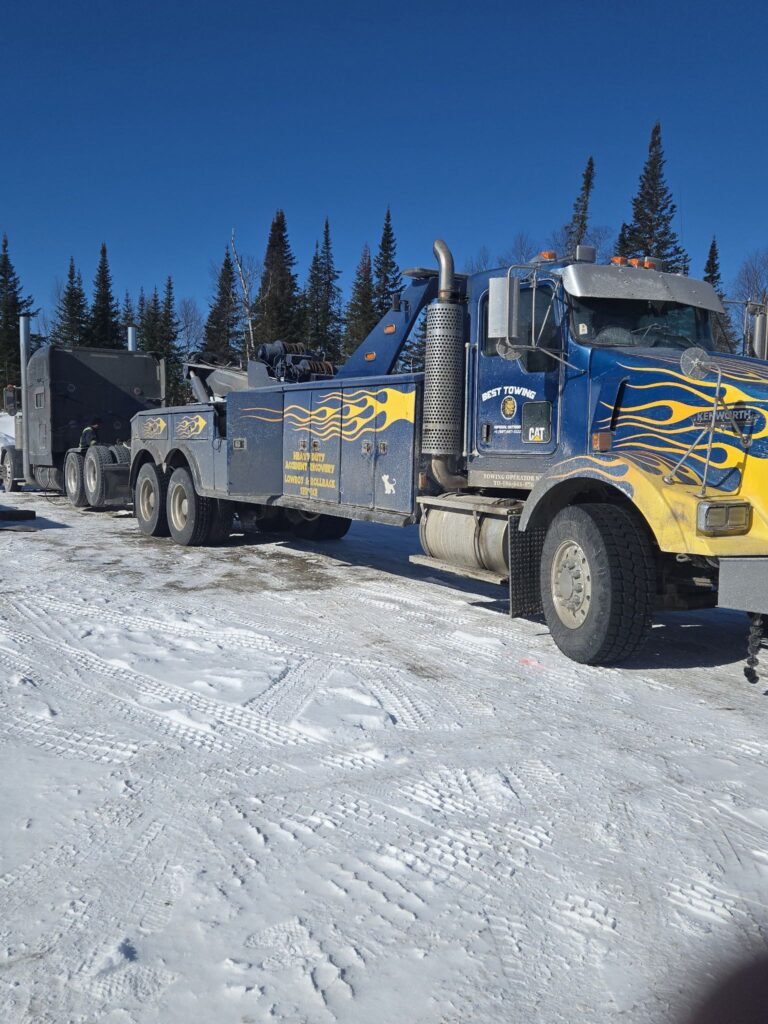 best towing serviceBest Towing heavy-duty recovery truck with flame decals parked on a snowy lot in Ontario.