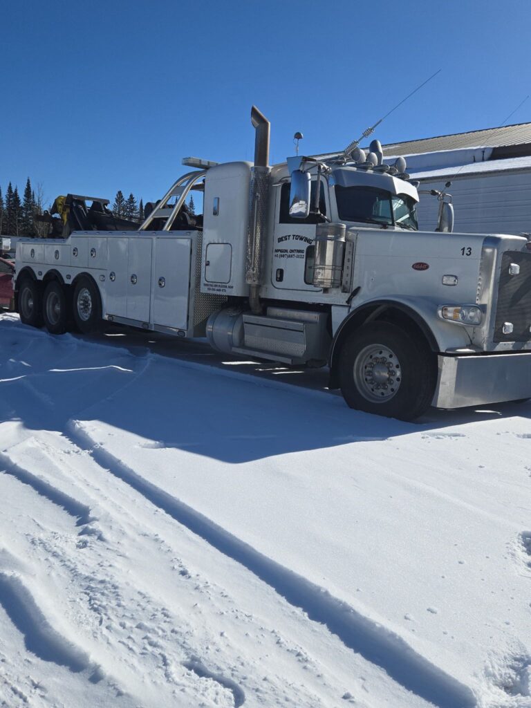 Best Towing heavy-duty tow truck parked in snow.