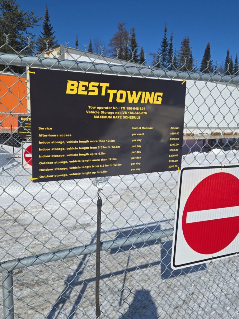Towing Service Rate sign with vehicle storage prices